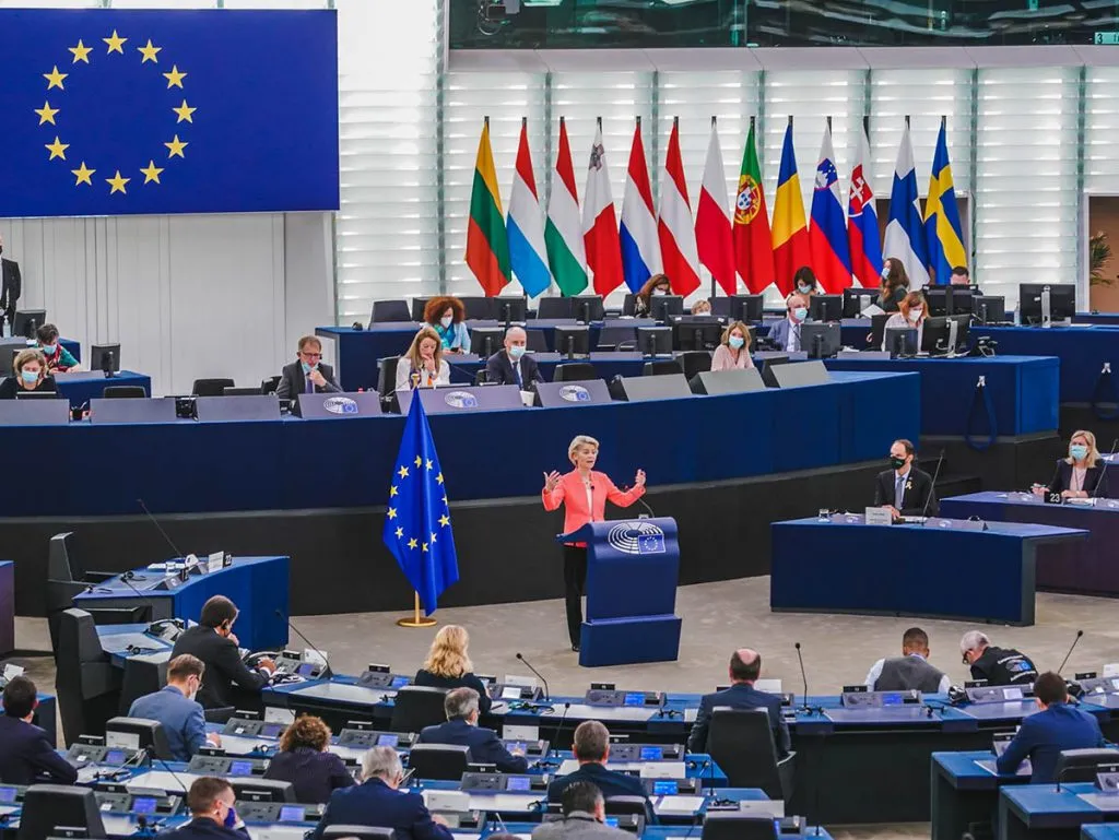 Ursula von der Leyen standing at a lecturn, addressing the European Parliament.