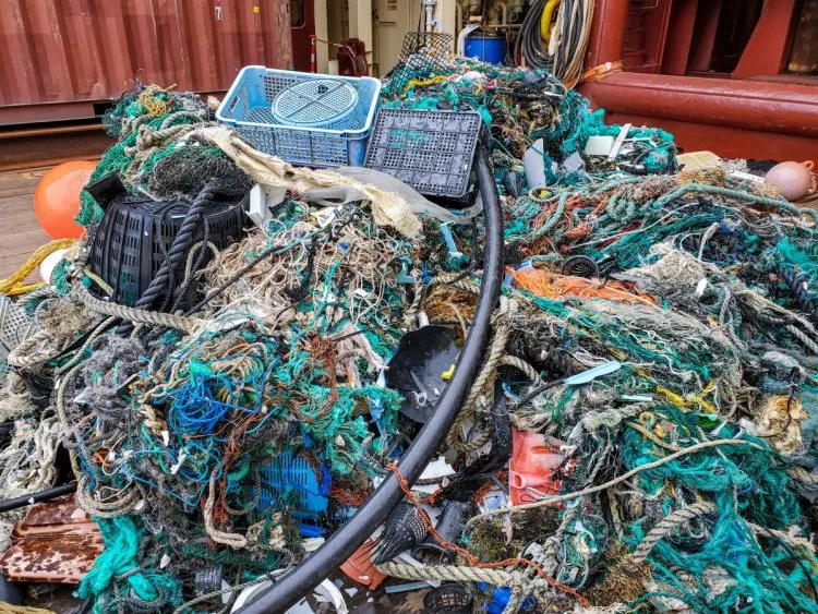 A heap of waste plastic retrieved from the ocean. Much of it is discarded fishing nets.