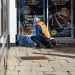 St Martins worker visiting a rough sleeper. The person is sleeping in the doorway of Marks & Spencer.