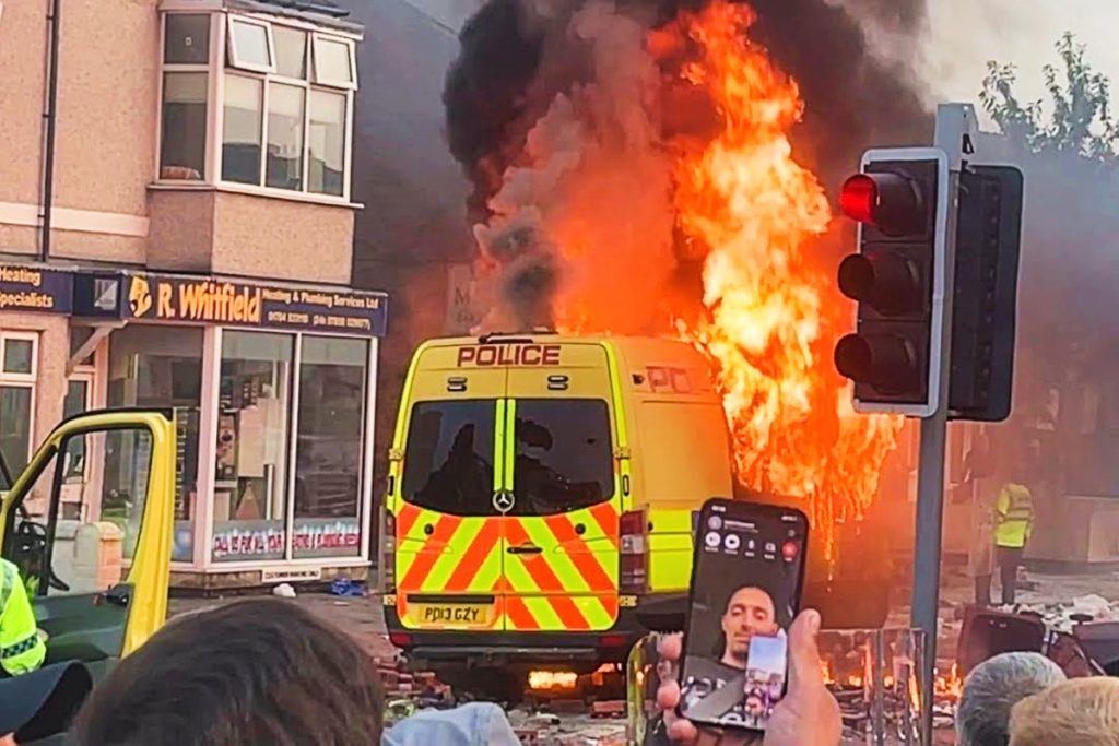 Police van on fire during the 2024 Southport riot
