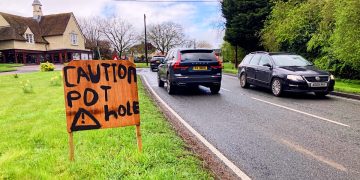 Resident made sign in Great Easton, Essex reads: "Caution: pot hole"