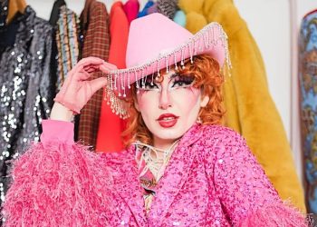 Shameless Heaney drag act wearing a pink cowboy hat
