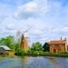 Hunsett Windmill, with adjacent house on Norfolk Broads on a bright blue sky day