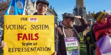 Make Votes Matter protest at Westminster. One activist holds a banner that says, "Our FPTP voting system fails to give us representation in govt".