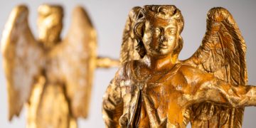 Two beautiful small golden gilded wooden angels.