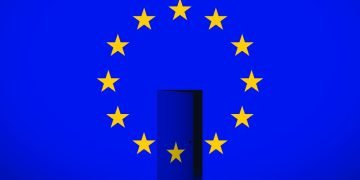 EU flag with a half-open door at its centre, revealing darkness beyond.